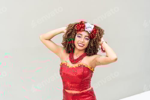 Preview: Woman with hands on head smiling in a red carnival costume