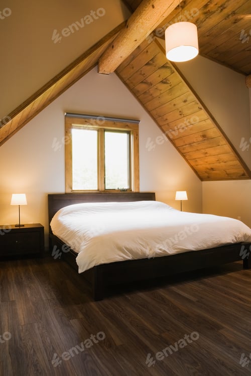 Preview: Vaulted ceiling and double bed below window in modern bedroom