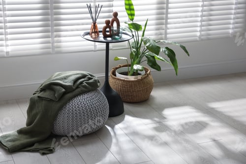 Preview: Stylish knitted pouf with plaid and home decor indoors