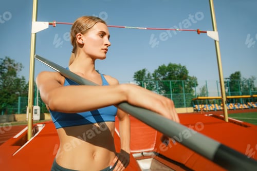 Preview: Female high jumper training at the stadium in sunny day