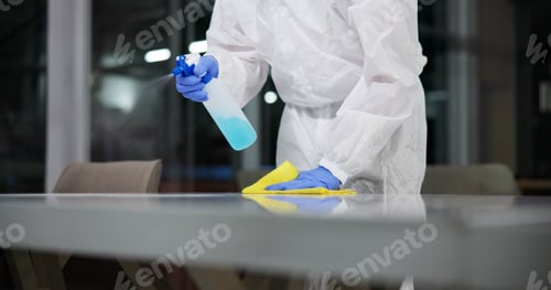 Preview: Cleaner, cleaning table and person in office for fumigation, spray disinfect and safety suit from d