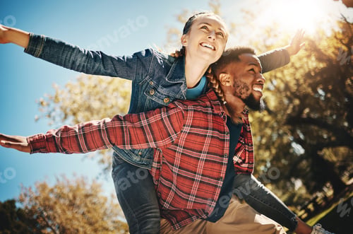 Preview: Happy couple, flying arms and piggyback in park, summer and date together in sunshine, happiness an
