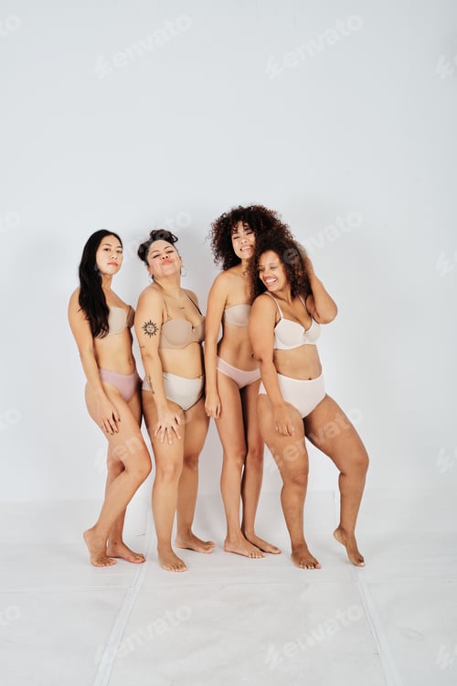 Preview: Delighted young different diverse females in underwear standing in studio