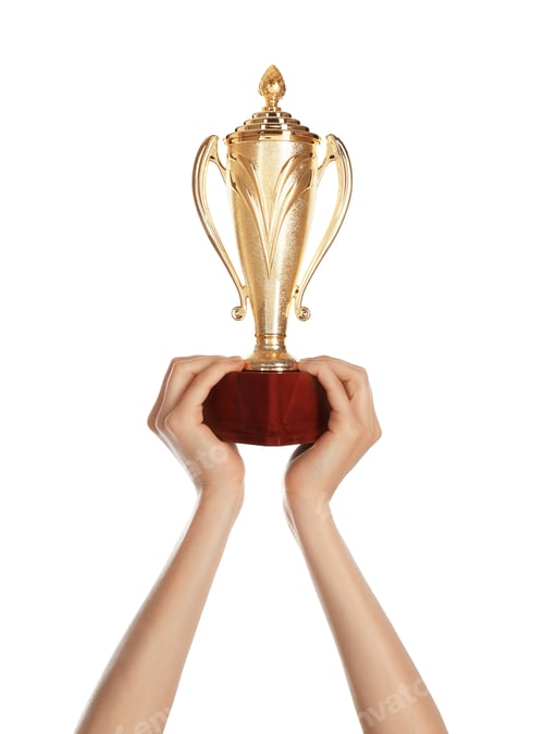 Preview: Young woman holding gold trophy cup on white background, closeup