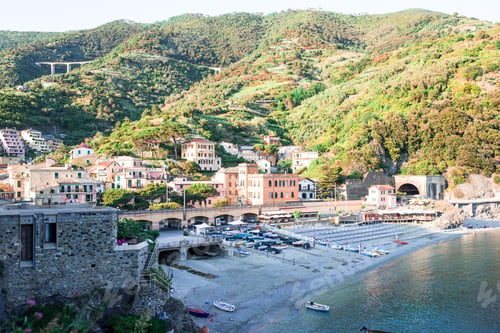 Preview: Empty beach with closed umbrellas on italian coast