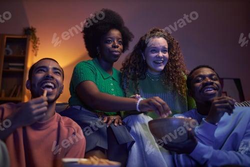 Preview: Group of excited young people watching TV
