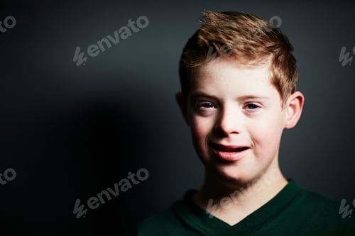 Preview: Smiling boy with a confident gaze in a moody portrait