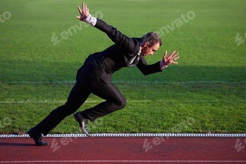 Preview: Business Man In Start Position Ready To Run And Sprint On Athletics Racing Track
