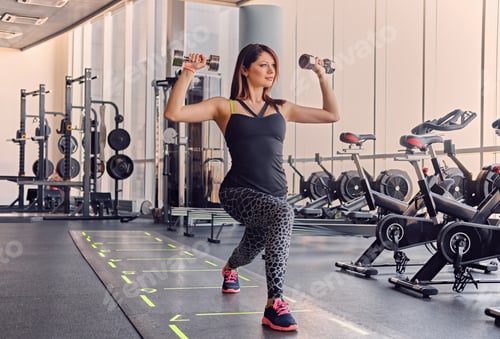 Preview: Female doing squats in a gym.