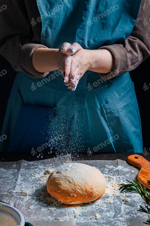 Preview: Woman is preparing homemade bitten fresh herb bread rolls of Provencal herbs with salt and garlic