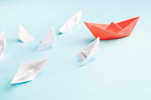 Preview: Unsuccessful leadership concept. Red paper boat and a lot of sinking ships