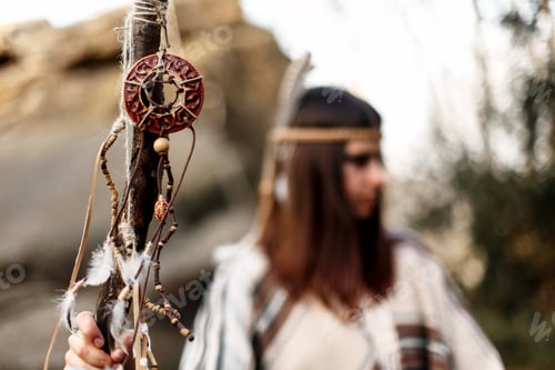 Preview: beautiful native indian american woman holding pikestaff with dreamcatcher