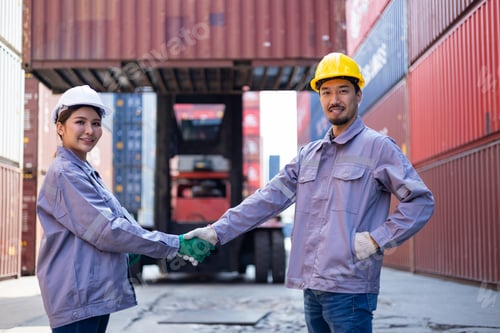Preview: Engineers shaking hands congratulating themselves on success with shipping containers
