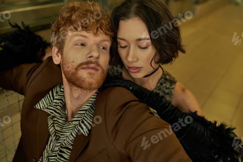 Preview: portrait of young stylish interracial couple posing together in public laundry