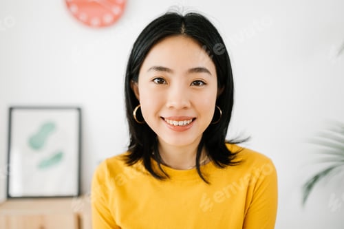 Preview: Portrait of happy asian teenager girl student smiling at camera indoors