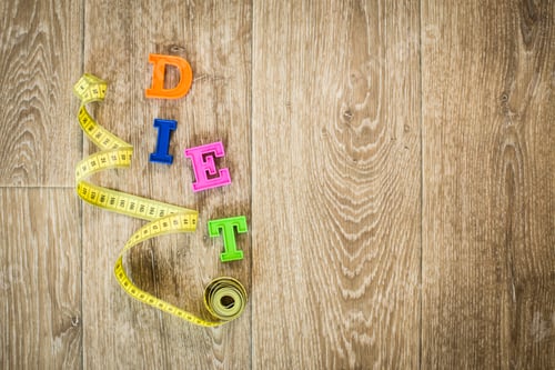 Preview: measuring tape on a wooden background. diet concept