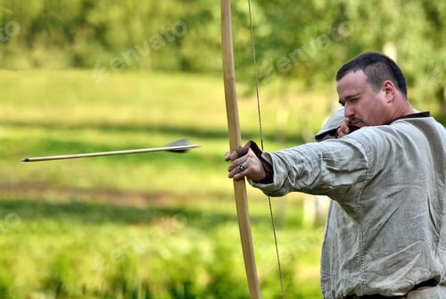 Preview: An archer wearing a historic dress demonstrates shooting skills. ❤️ nominated 💔