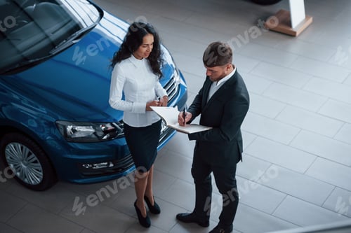 Preview: Female customer and modern stylish bearded businessman in the automobile saloon