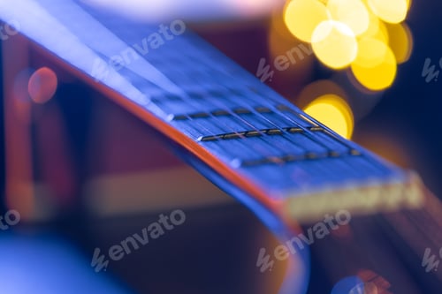 Preview: Part of an acoustic guitar, guitar fretboard on a black background.