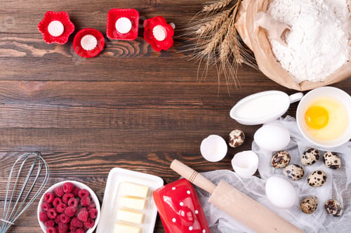 Preview: Baking background. Flour in paper bag, eggs, butter, milk, rolling pin, berries, whisk