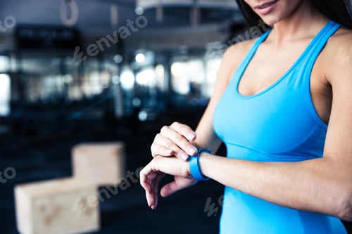 Preview: Woman Using Activity Tracker At Gym
