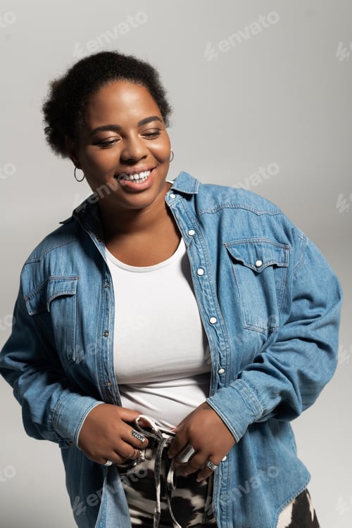 Preview: Stylish plus size woman showcases autumn fashion in a modern studio setting