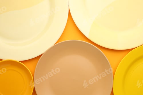 Preview: Beautiful multi-coloured bright ceramic bowl and tarenes, on a table top view