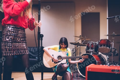 Preview: Young woman musician playing acoustic guitar