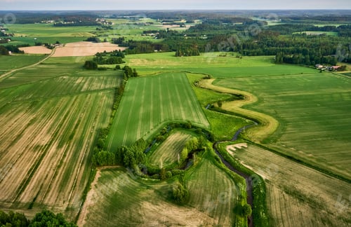 Preview: Aerial view of the vast rolling hills of rural farmland with lush green vegetation
