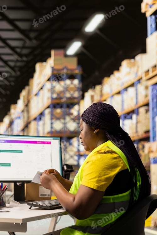 Preview: Black stock room clerk handling the airway bill labels for the goods