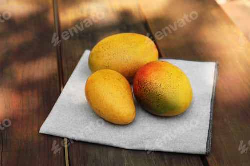 Preview: Many tasty mango fruits on wooden table outdoors