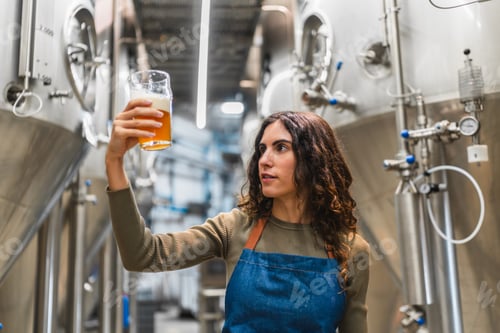 Preview: Woman inspecting beer quality in brewery production