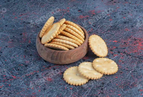 Preview: Biscuits in a small bowl on abstract background