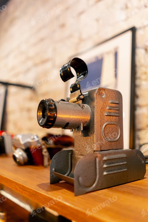 Preview: A rare antique projection device for broadcasting films stands on wooden shelf in an antiques store