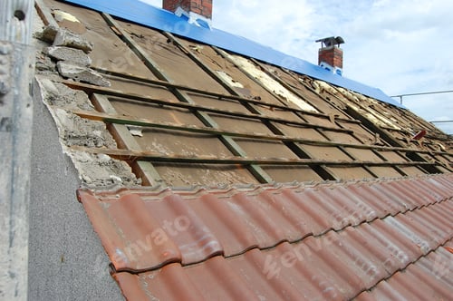 Preview: Work on a roof. Partly removed roof tiles and still old insulation.