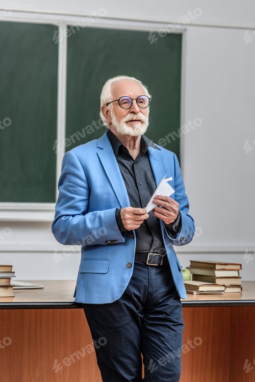 Preview: grey hair professor holding paper plane in lecture hall