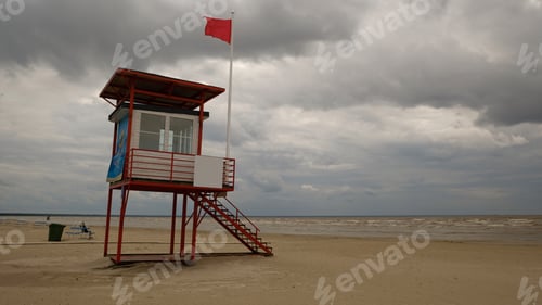 Preview: Rescue tower, red flag, swimming is prohibited. The concept of rescue work. Beach safety.