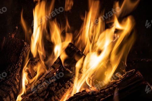 Preview: Fire orange tongues on black background in a brick fireplace