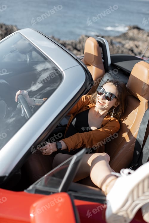 Preview: Woman enjoying summer vacation while traveling by car