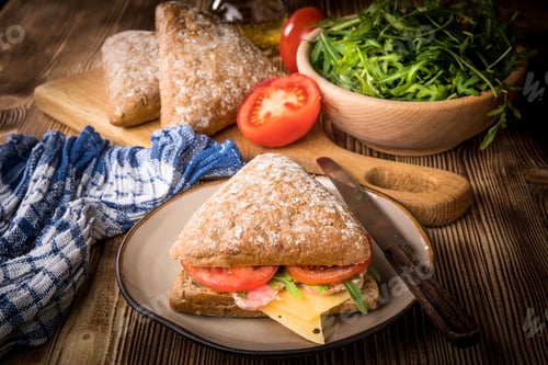 Preview: Triangular sandwich with cheese, ham and tomato.