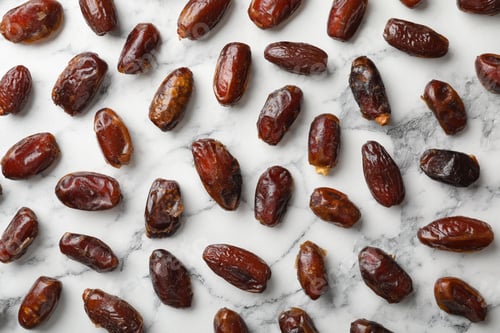 Preview: Flat lay composition with dates on marble background. Dried fruit as healthy snack