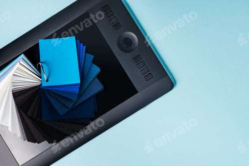 Preview: Top View of Color Samples on Graphics Tablet on Blue Background With Copy Space