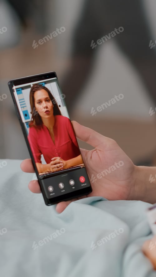 Preview: Sick patient resting in bed with mother greeting remote friend during online videocall conference