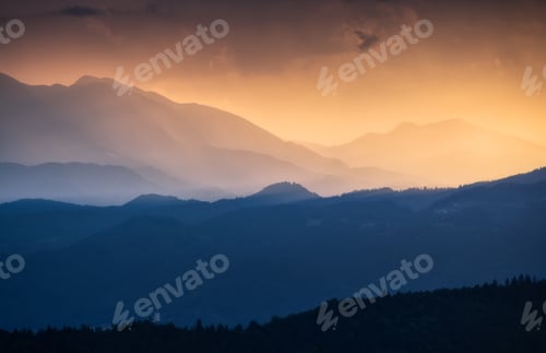 Preview: Amazing silhouettes of a mountains at colorful sunset in summer