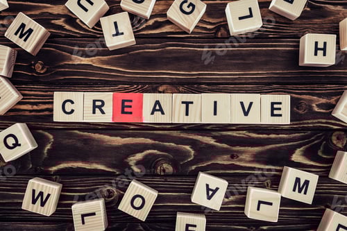 Preview: flat lay with blocks arranged in creative word on brown wooden surface