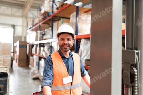 Preview: Confident Employee Operating Machinery At Warehouse