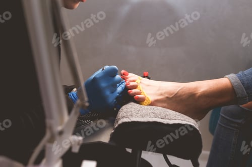 Preview: Master does pedicure for client. Pedicure process. Girl draws toenails