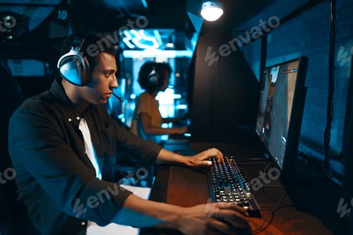 Preview: A gamer is using a computer to play video games with headphones on