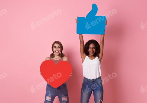 Preview: couple woman cheerful smile showing red heart with like icon symbol on pink studio background.