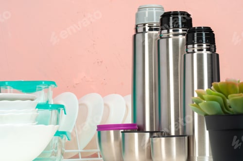 Preview: Thermos bottle against tableware in a kitchen